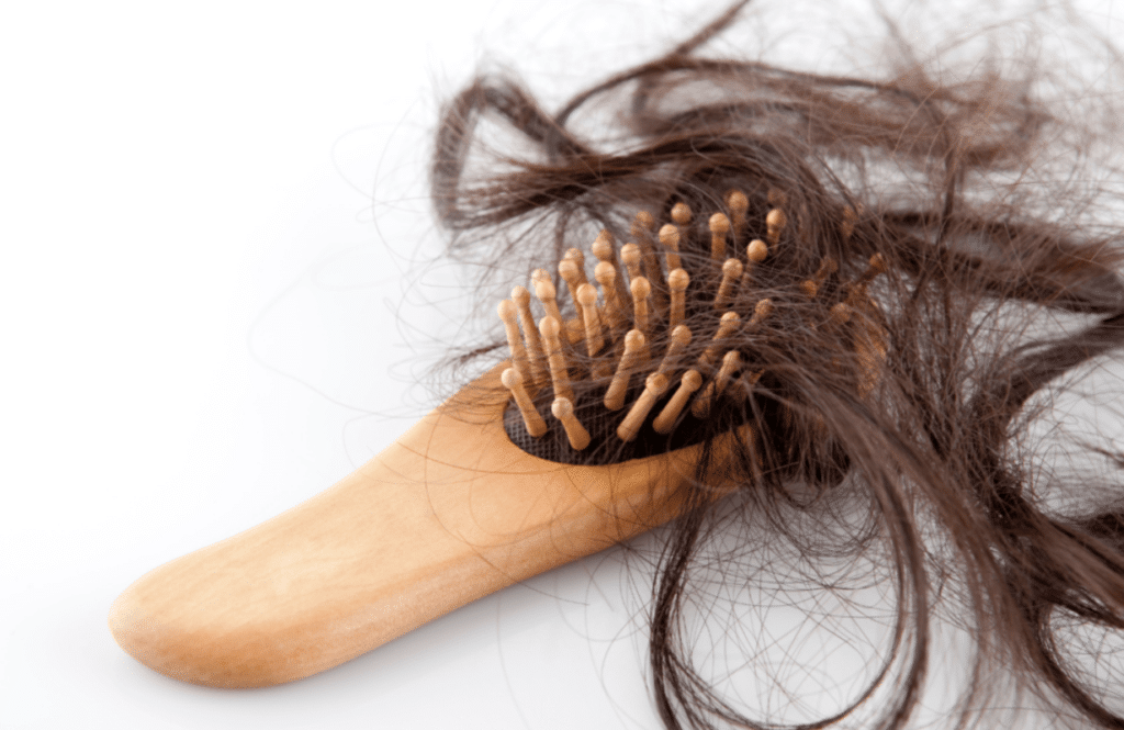 Hair coming out on a hairbrush.