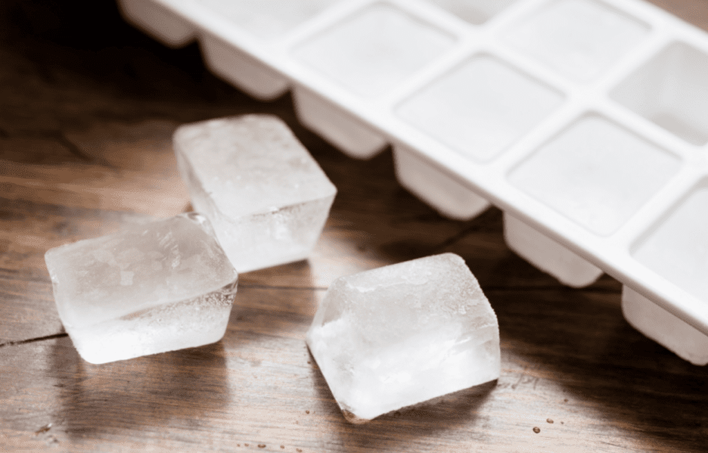 Frozen ice cubes and an ice cube tray.