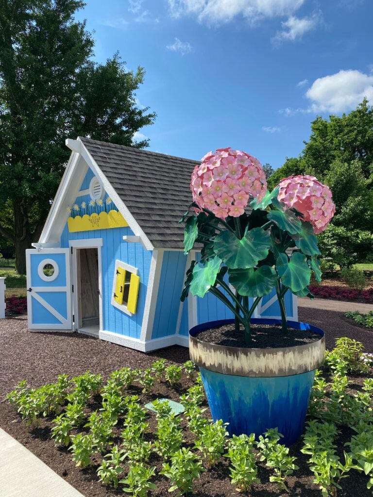 Margie's Children's Garden at Boerner Botanical Garden - blue house with pink flower statue