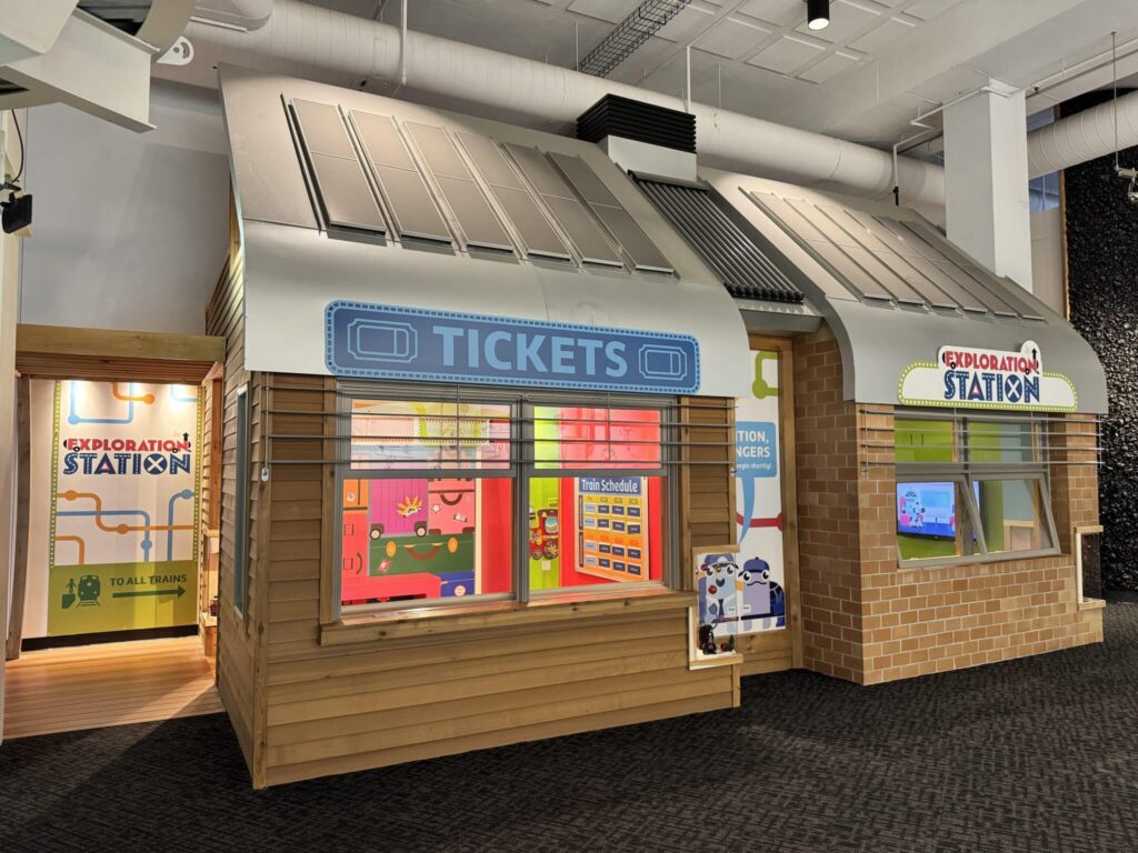 Ticket Booth with blue sign that says "Tickets" at Discovery World's Exploration Station exhibit in Milwaukee, Wisconsin.