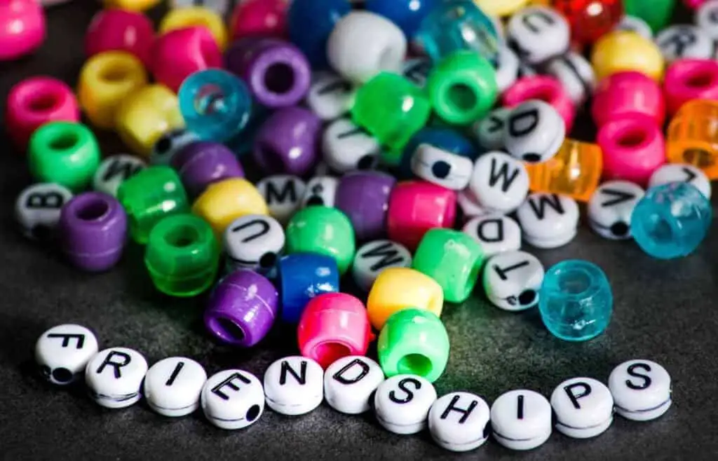 Colorful beads spelling friendships for bracelet making activity