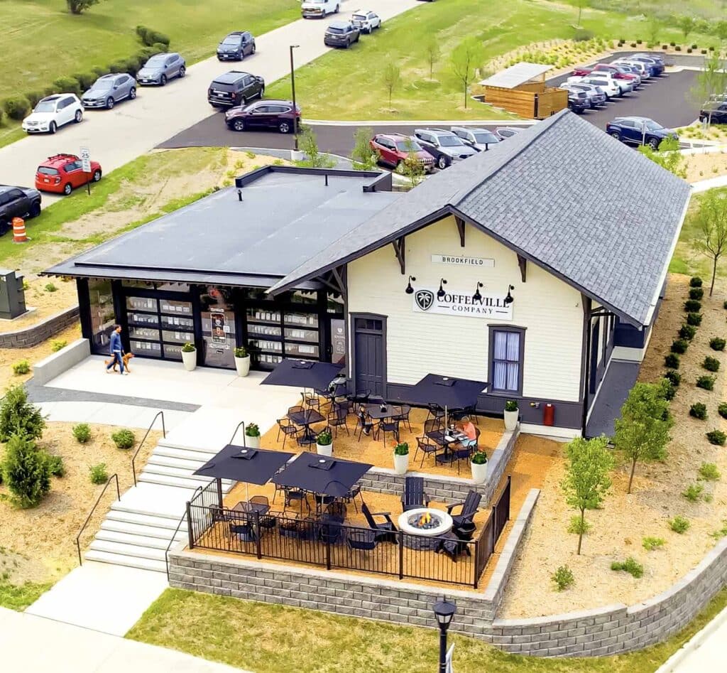 Coffeeville Company in Brookfield, Wisconsin, located in a restored train depot with outdoor seating and modern landscaping.