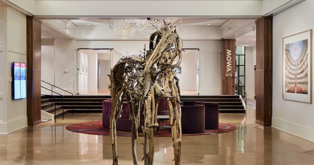 Lobby of with art works on the wall and sculpture in the center