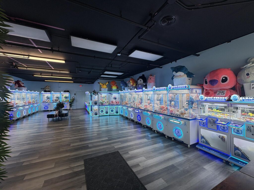 Brightly lit claw machines and oversized stuffed animals at an arcade in Brookfield, Wisconsin