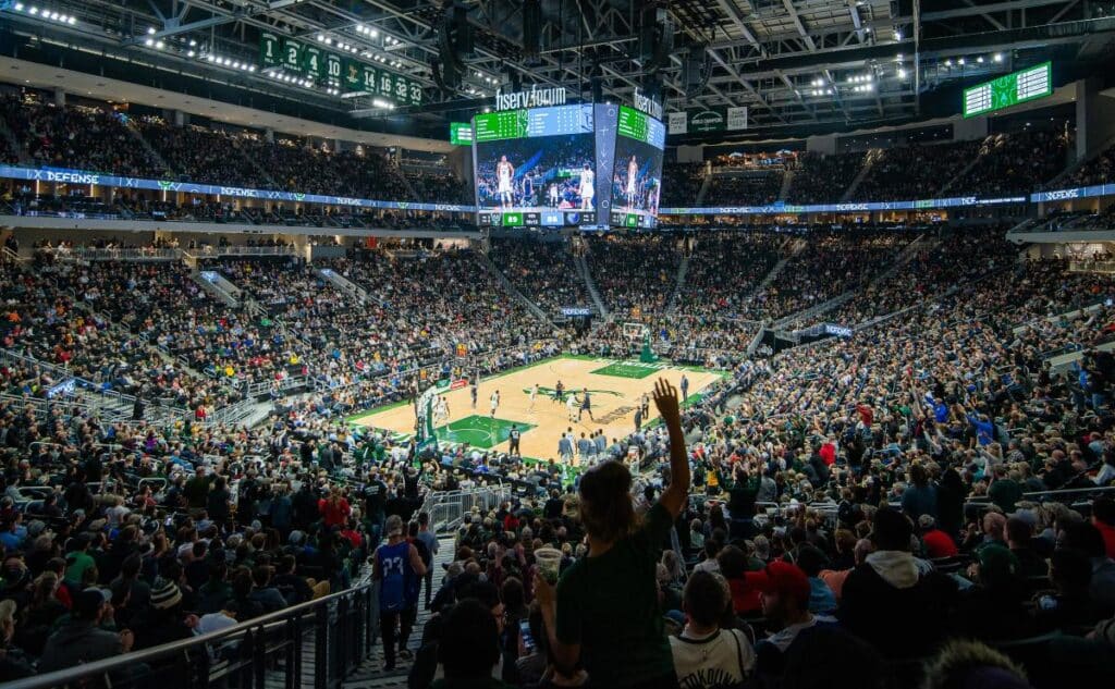 People cheering at a basketball game inside the stadium at Fiserve Forum