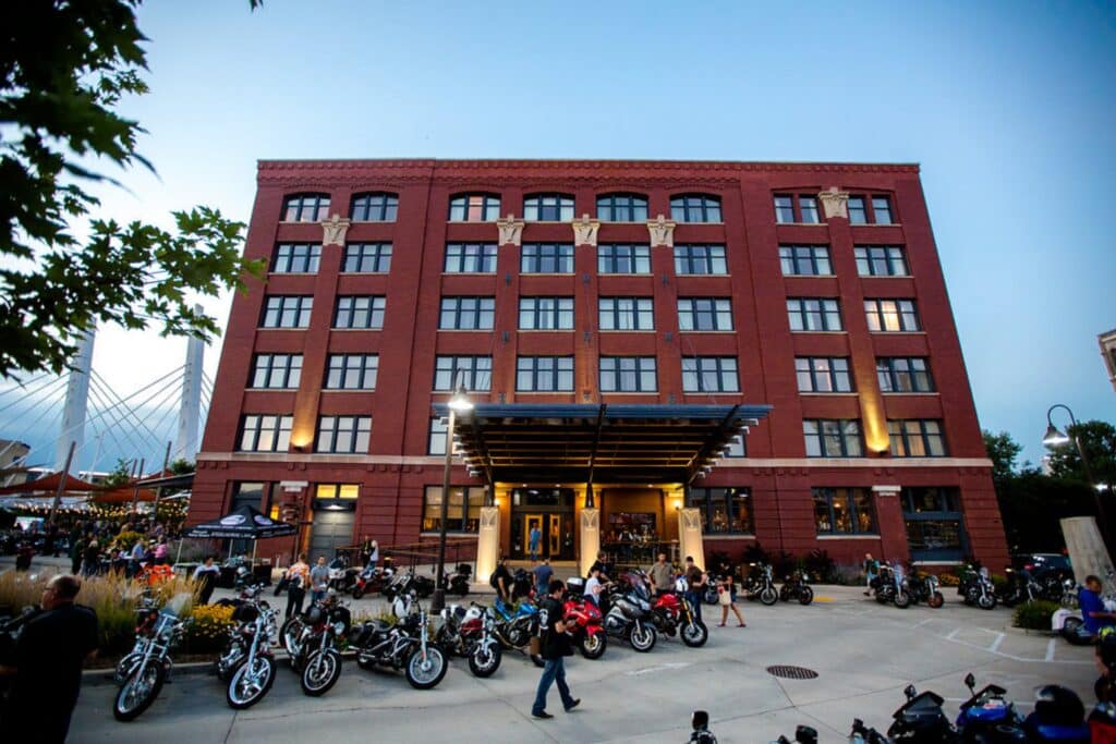 Front view of Walker's Point Hotel with rows of parked Harley Davidsons 