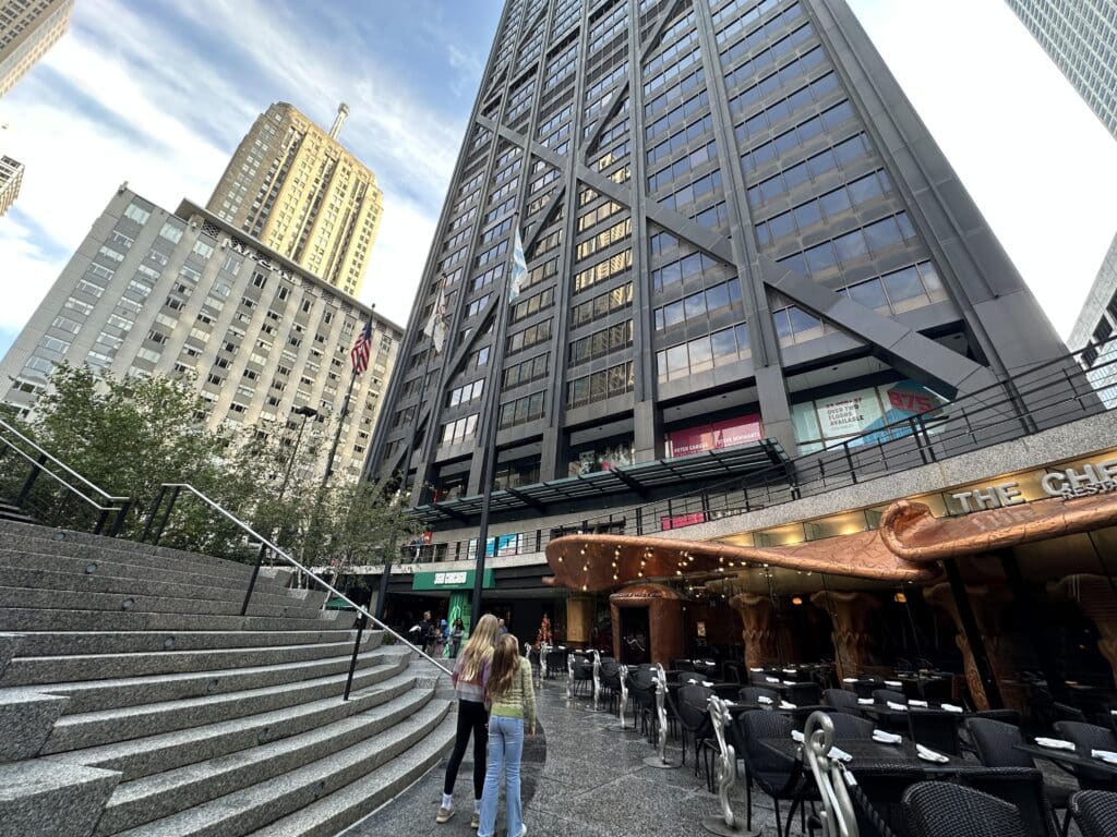 Children walk toward the base of the John Hancock Center in downtown Chicago, where 360 Chicago is located