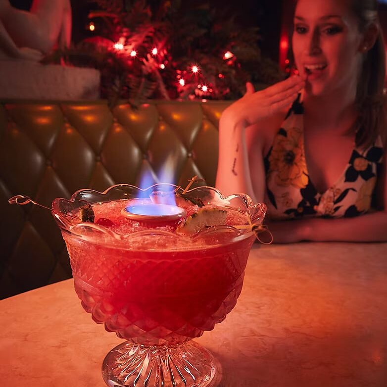 Couple sharing a Tiki Love Bowl cocktail at At Random in Bay View Milwaukee