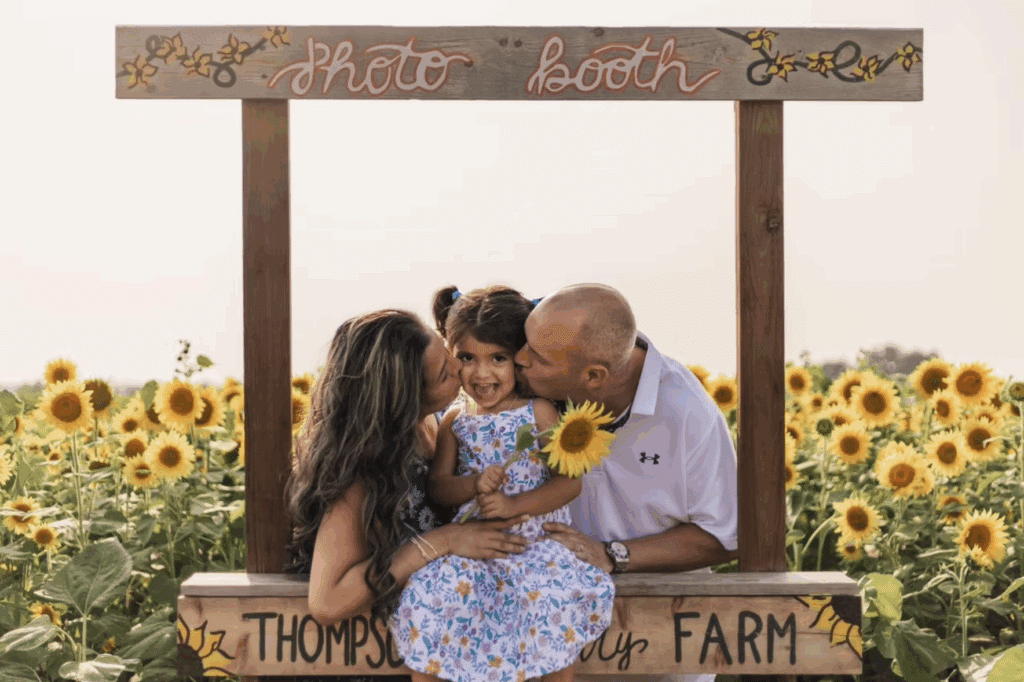 Family enjoying the sunflower fields photo booth at Thompson Strawberry Farm in Bristol, Wisconsin