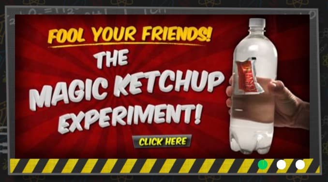 A hand holding a water bottle with a pack of ketchup