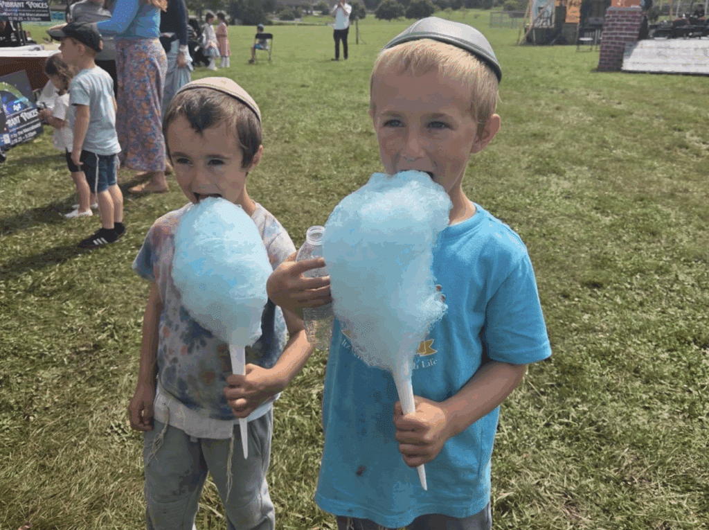 Two young boys enjoying blue cotton candy at the Jewish Food Festival in Mequon, Wisconsin.