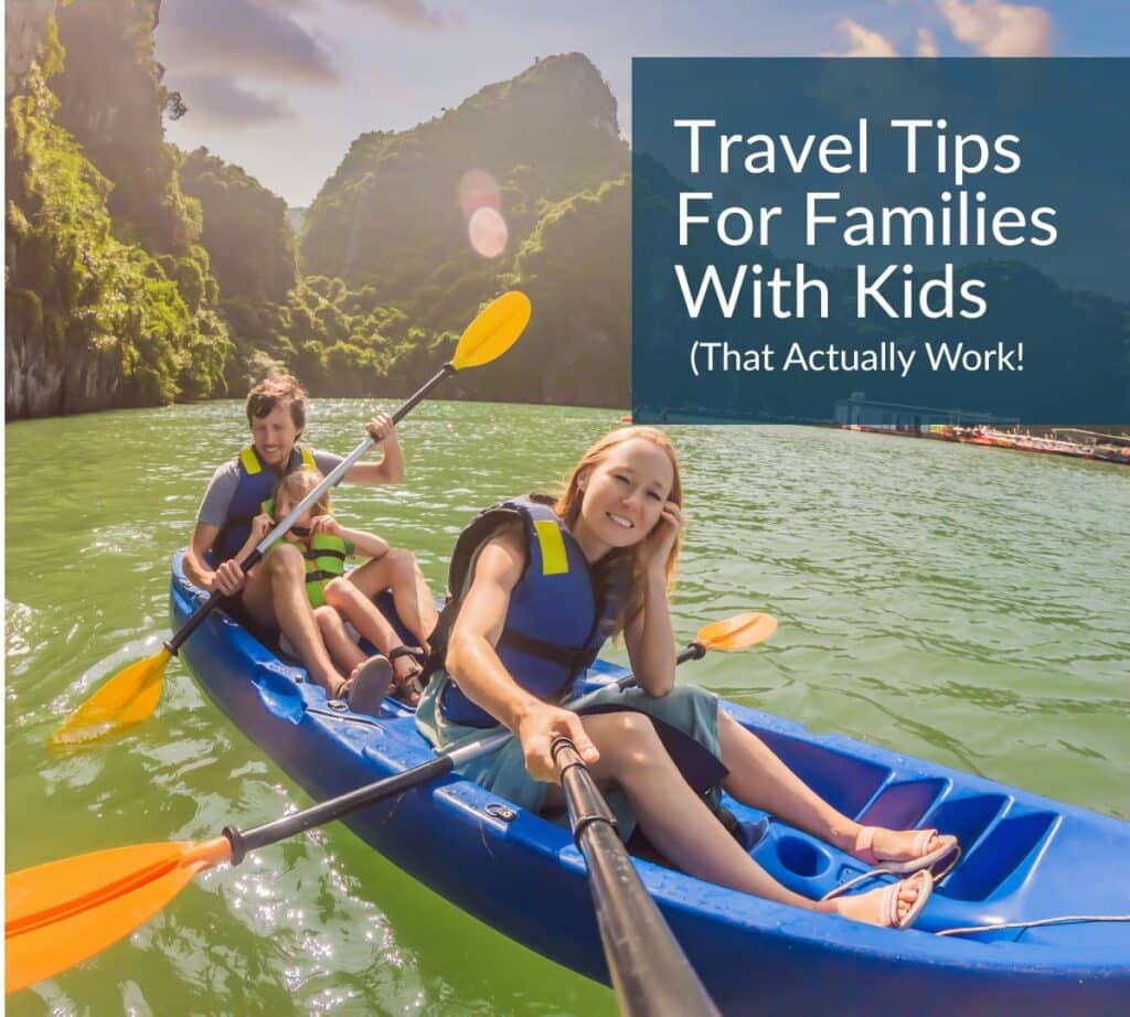 Family kayaking together in a tropical destination with lush green cliffs, wearing life vests — featured image for “Travel Tips for Families With Kids” blog post.