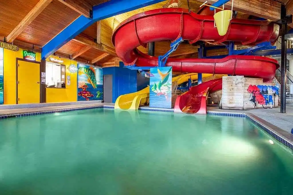 Small indoor hotel water park with slide at AmericInn Ashland Wisconsin