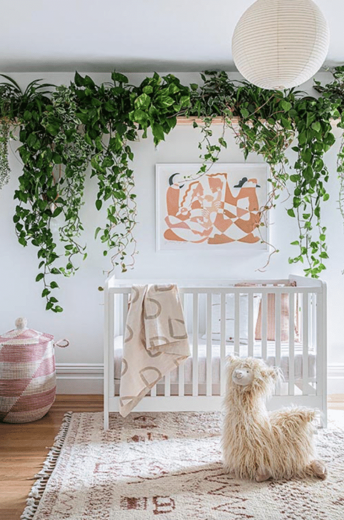 Baby girl nursery with lux faux vine wall accent, white walls, woven carpet and Japanese lantern, representing a plant-inspired design.