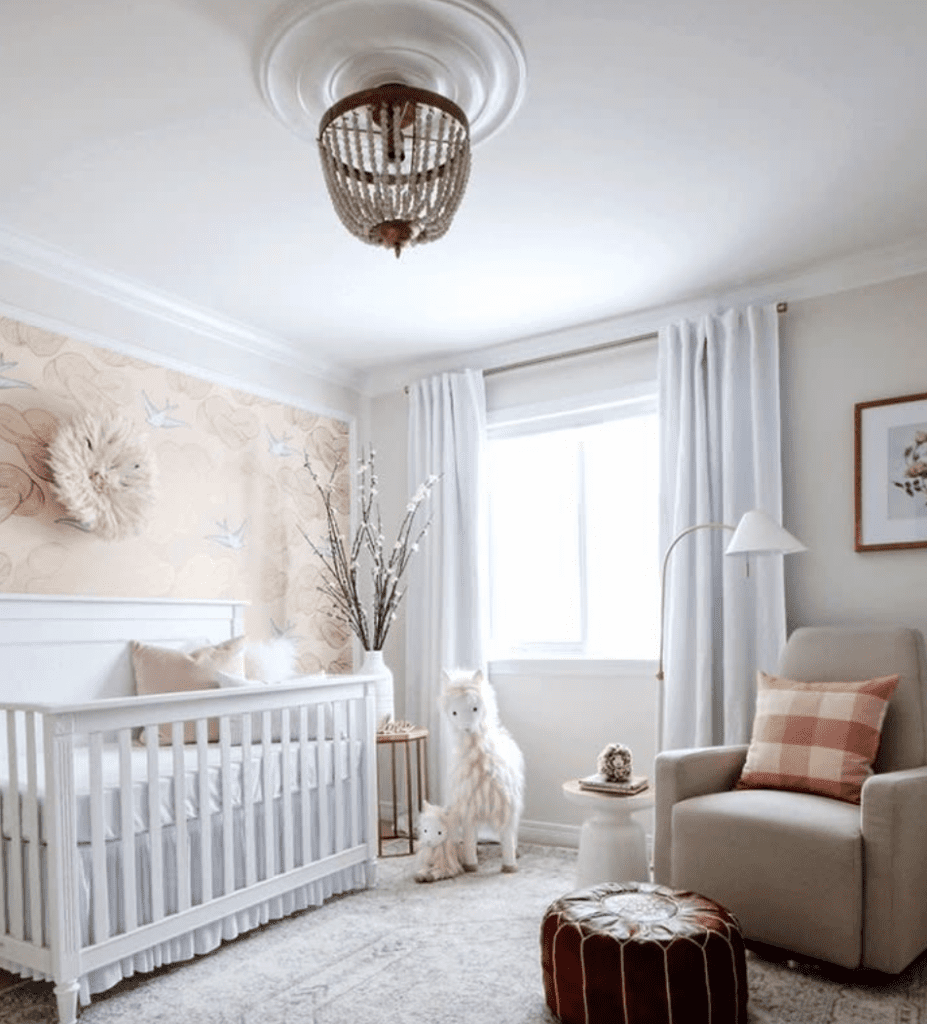 Baby girl nursery with warm wood accent, white walls and curtains inspired by an all-white nursery design