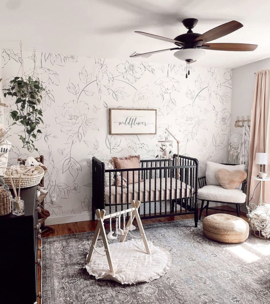 Baby girl nursery with a minimalist sunburst decal and wooden pallet rack used, showing airy and cheerful vibe of the sunshine inspired room