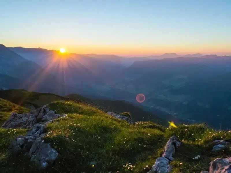 A glowing sunrise casting golden light across a hopeful landscape.