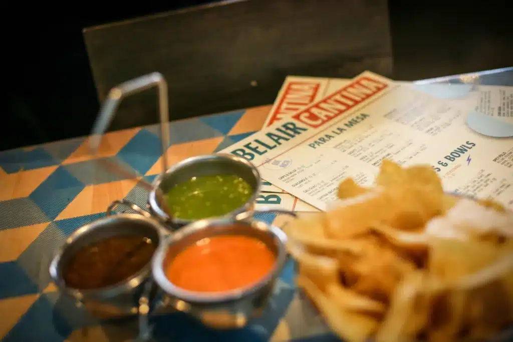 Belair Cantina menu with a plate of chips and  three kinds of dips in its Oak Creek branch