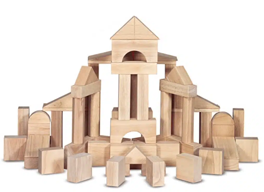 Square, triangle, oblong and rectangle wooden blocks stacked on top of anoother