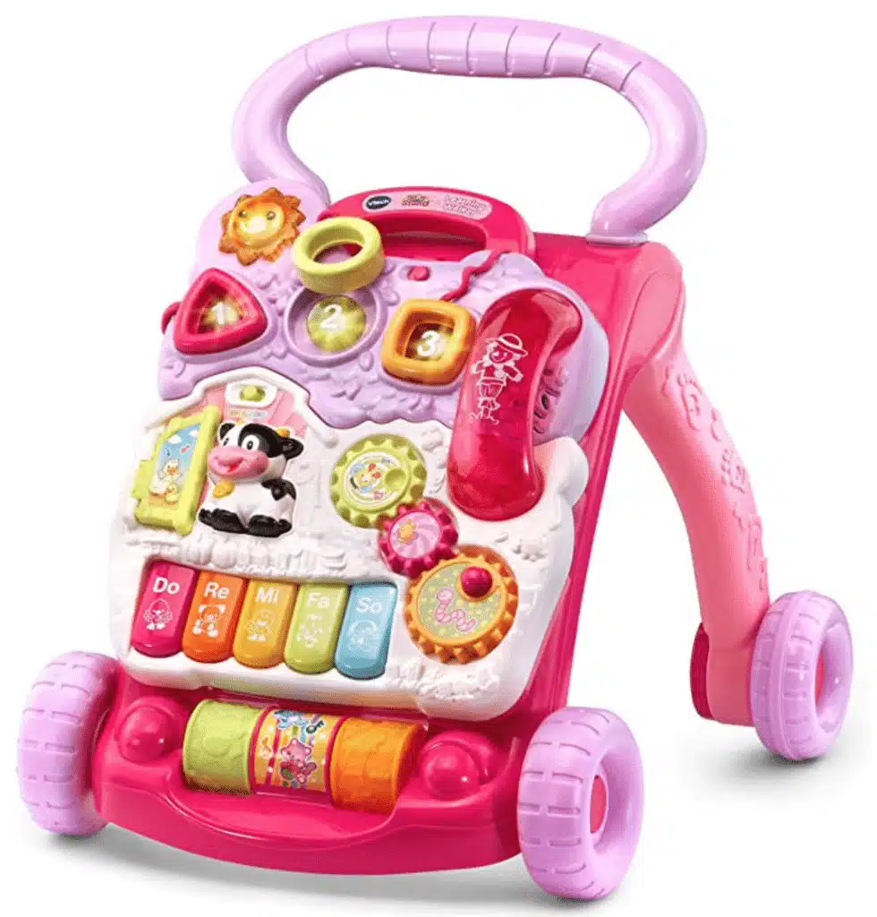 A pink learning walker with piano pieces, rollers and phone