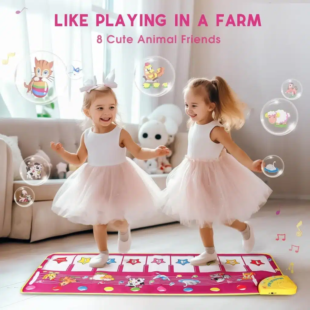 Two girls in pink dresses dancing on a giant musical mat