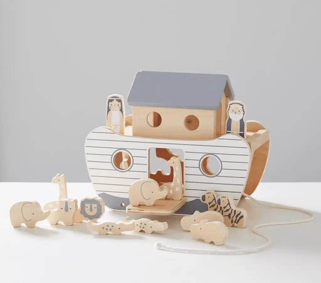 A wooden playset made up of an ark, animals, Noah and his wife