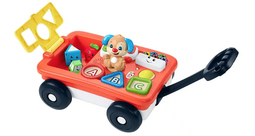 A pull-along wagon with a teddy beary and ABC blocks