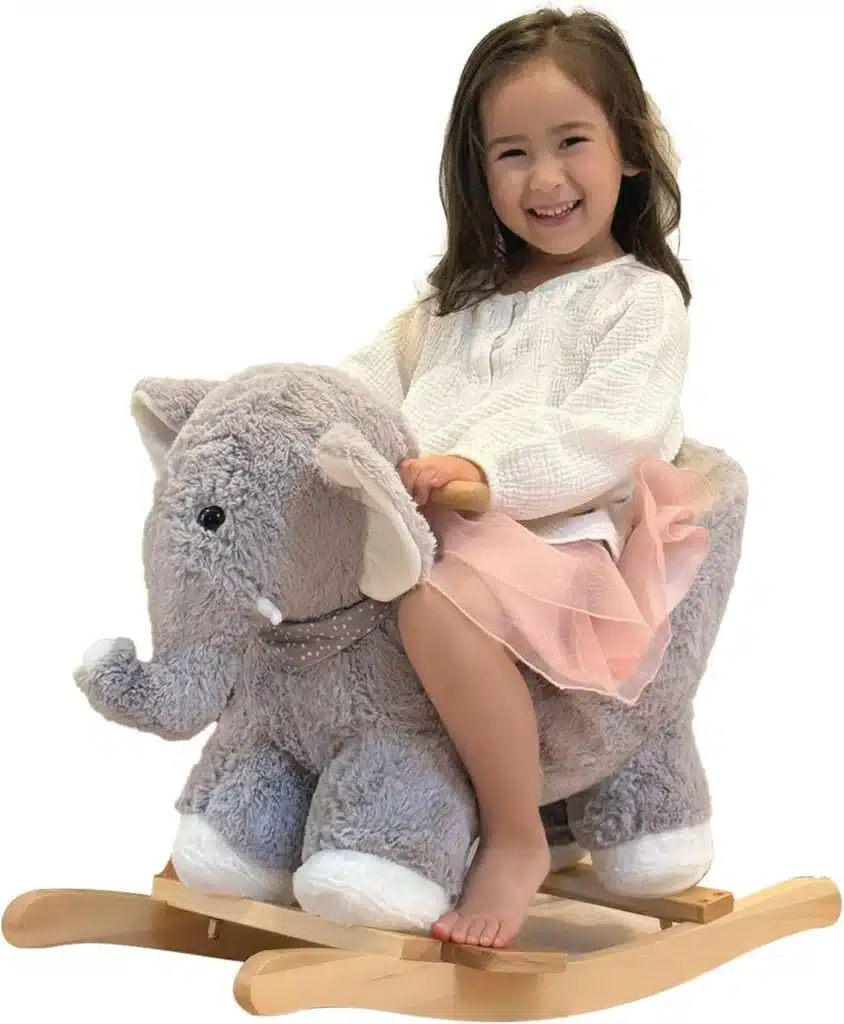 A little girl riding a plush elephant rocker