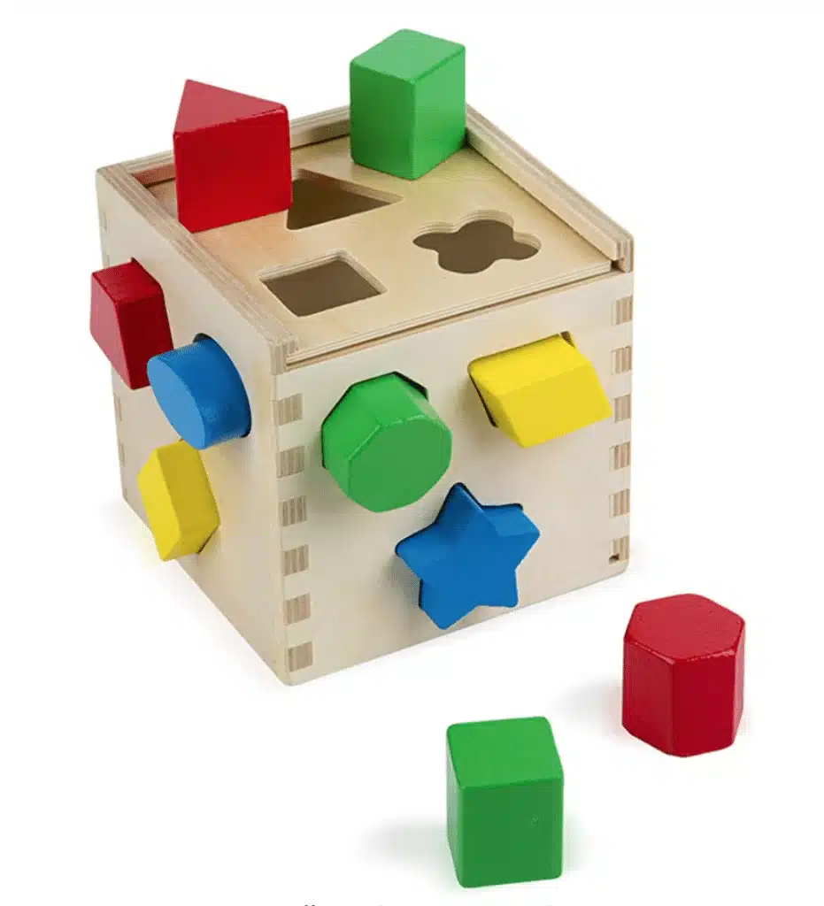 A wooden shape sorter witth octagon, star, circle, diamond, heptaton and triangle shapes