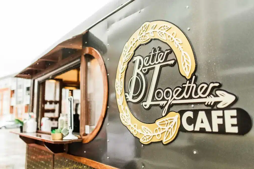 Coffee shop counter with a design that says Better Together Cafe on its side