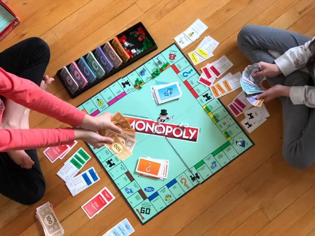 Kids playing Monopoly during a 12-year-old birthday party