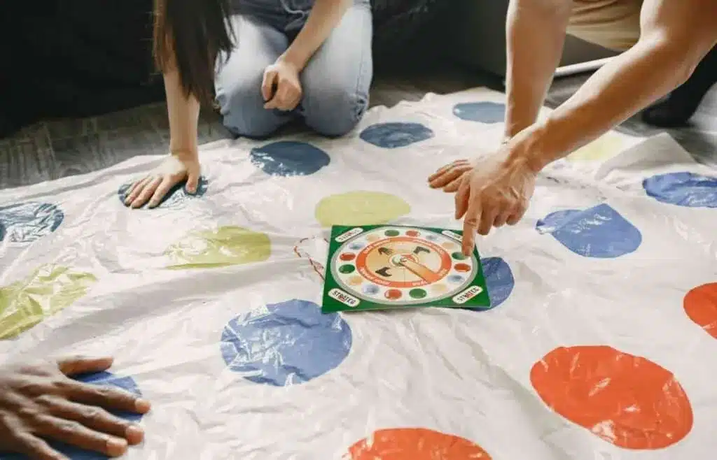 Kids playing Twister game at a 12-year-old birthday party