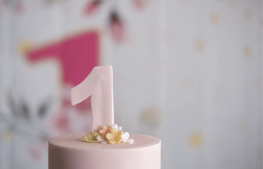 Cake with pink fondant and flower and the number 1 topper