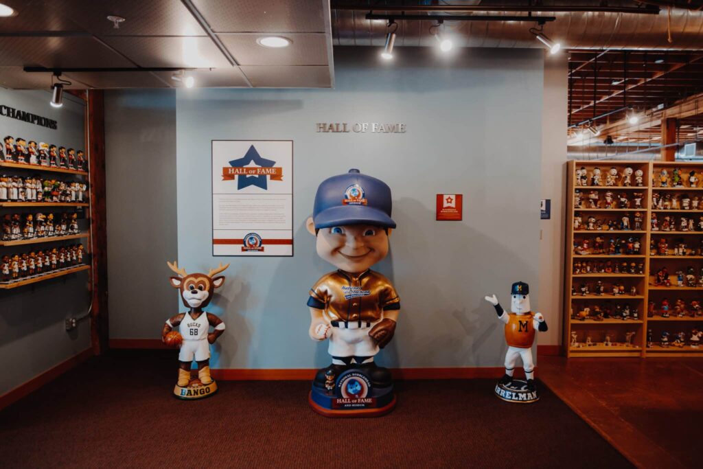 Giannt bobblehead statue and display walls at the Bobblehead Museum in Walker's Point, Milwaukee