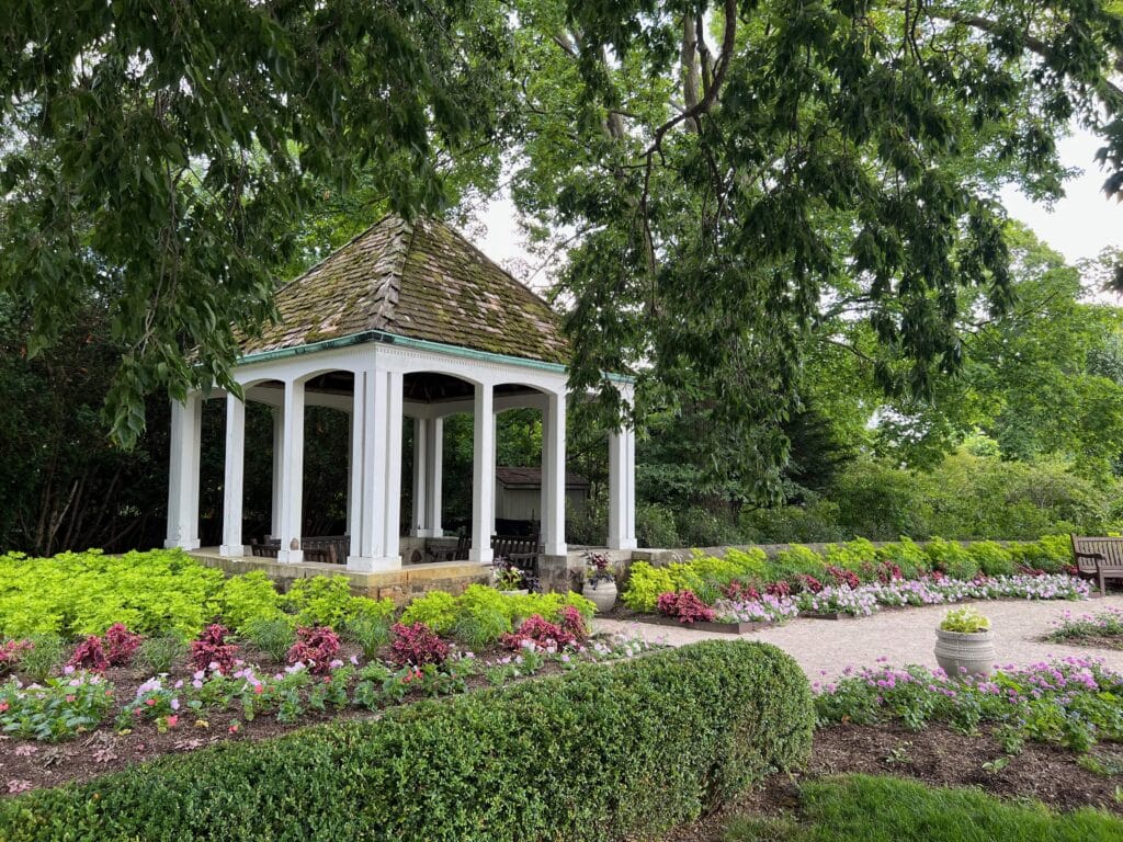A gazebo surrounded by small shrubs where adults can sit while there are kid activities at the Boerner Botanical Gardens