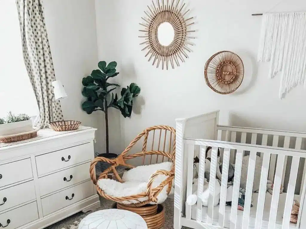 Botanical gender-neutral nursery with wicker chair, greenery accents