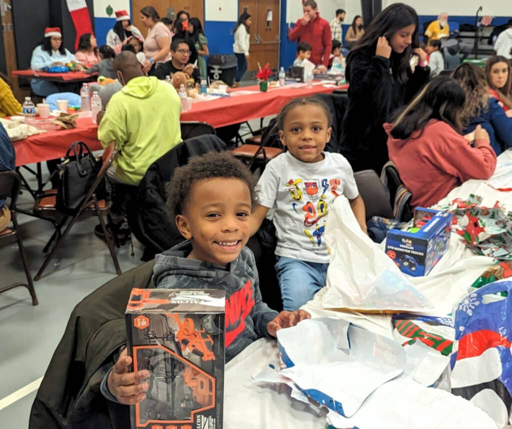 Happy kids after opening their Christmas presents at Dr. Martin Luther King Jr Community Center