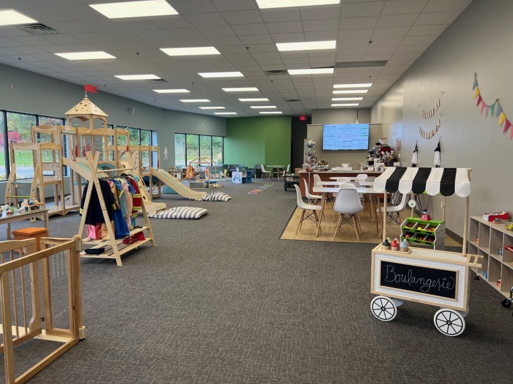 Pretend play sets such as ice cream stands and shops with wooden slides at Bug & Goose Play Cafe.