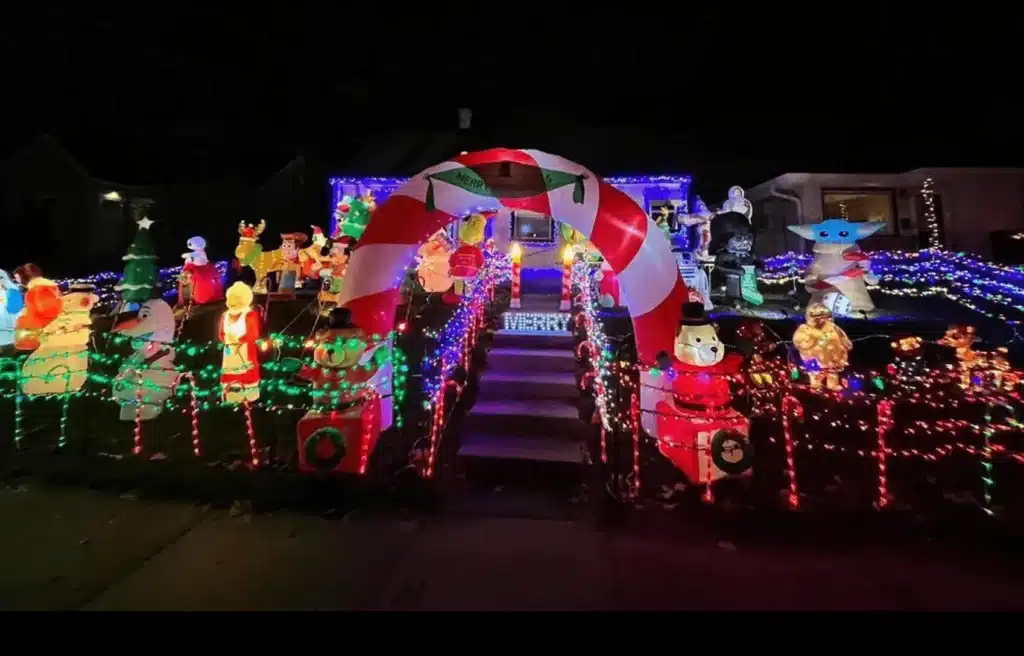 The entrance to the Candy Cane Lane with a candy cane style archway and Christmas lights.