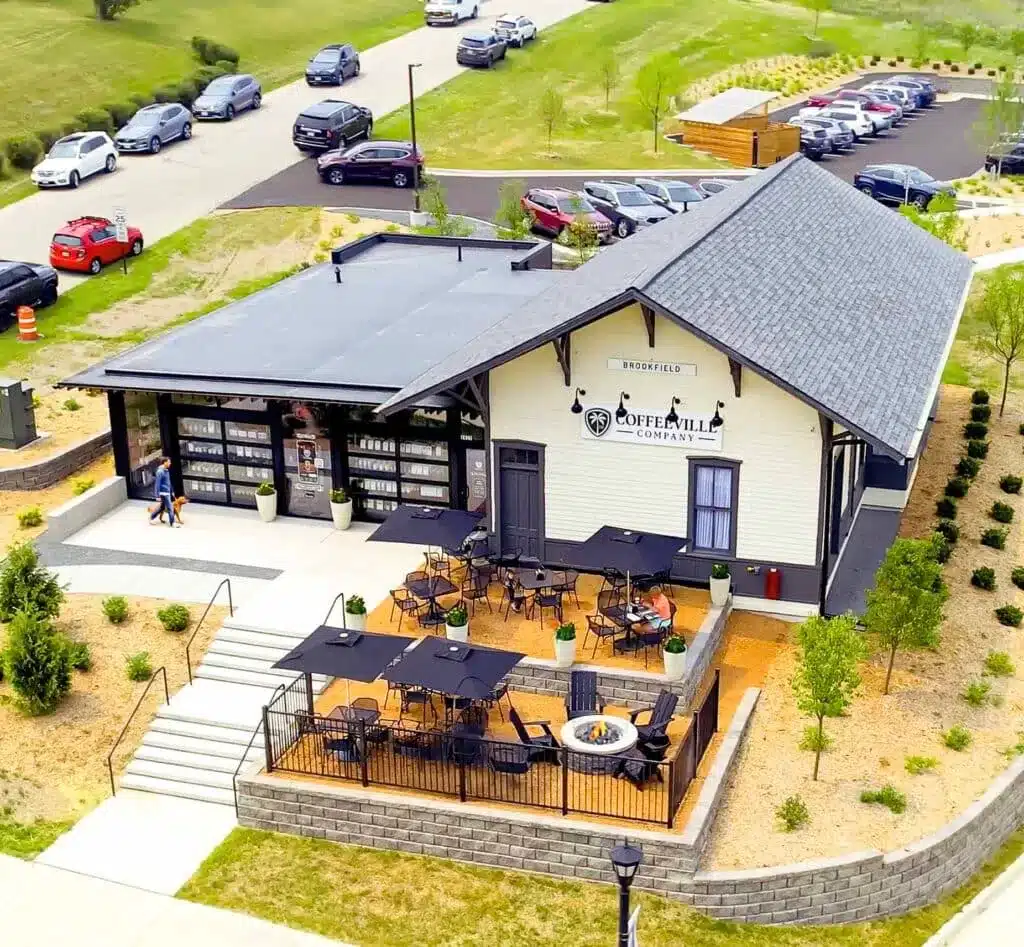 A man walking his dog and going towards the entrance of Coffeville Comapany in Brookfield
