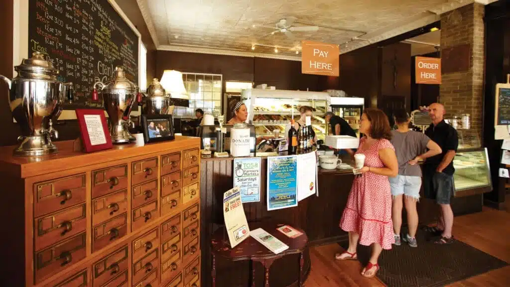 People talking at the counter while waiting for their coffee at Cranky Al's Donuts and Coffee