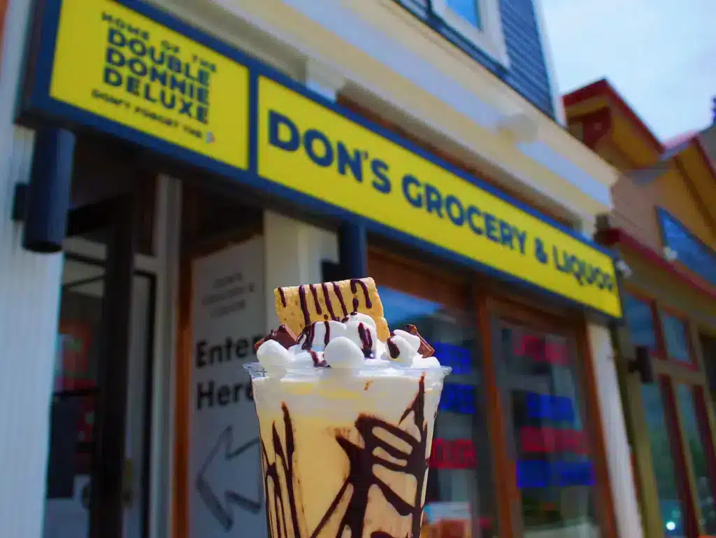 A glss of milkshake with marshmallows in front of Don's TV and Repair in Milwaukee