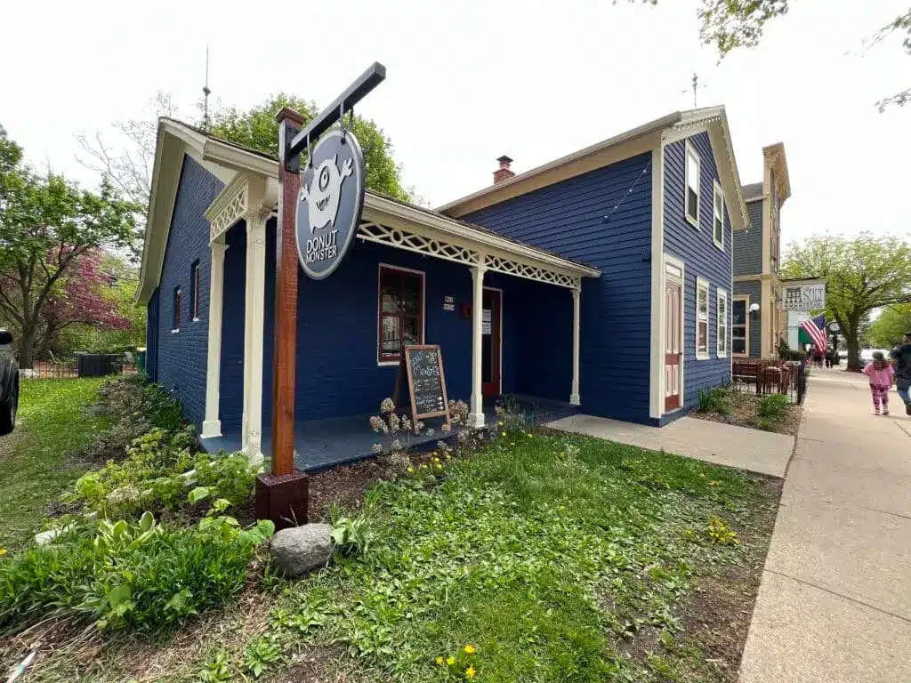 Blue-colored shop with white siding and a store marker with the name Donut Monster