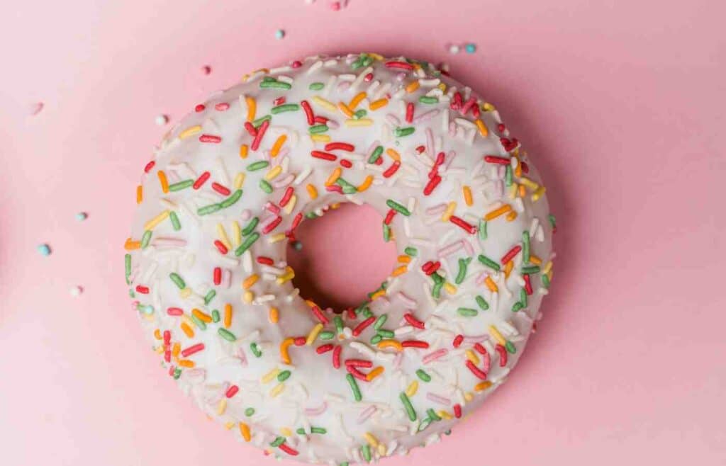 A donut with green, red and orange sprinkles