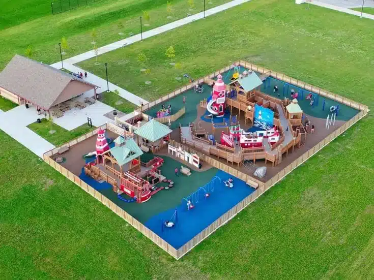 Aerial view of Dream Playground in Kenosha with inclusive play structures and fenced layout.
