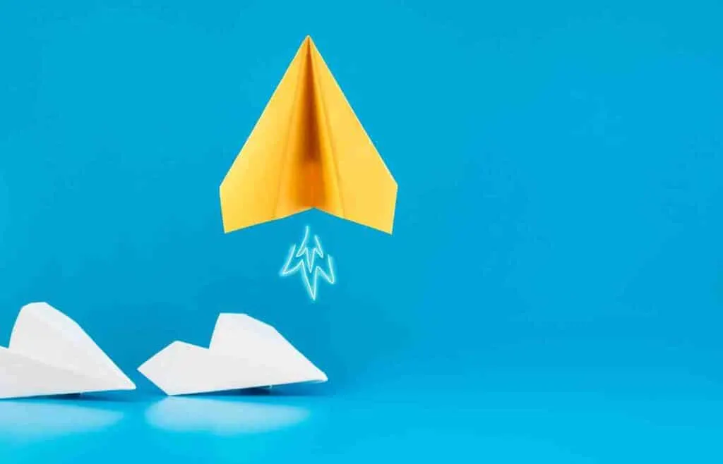 Paper airplanes on blue background used to test aerodynamics and flight distance