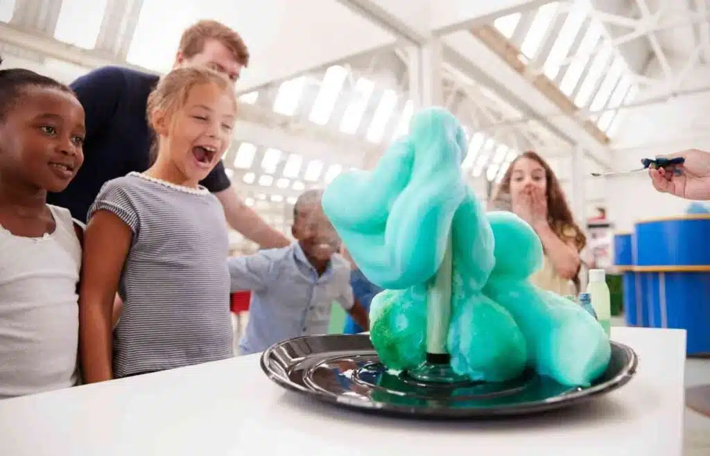 Kids reacting to elephant toothpaste foam erupting from a bottle