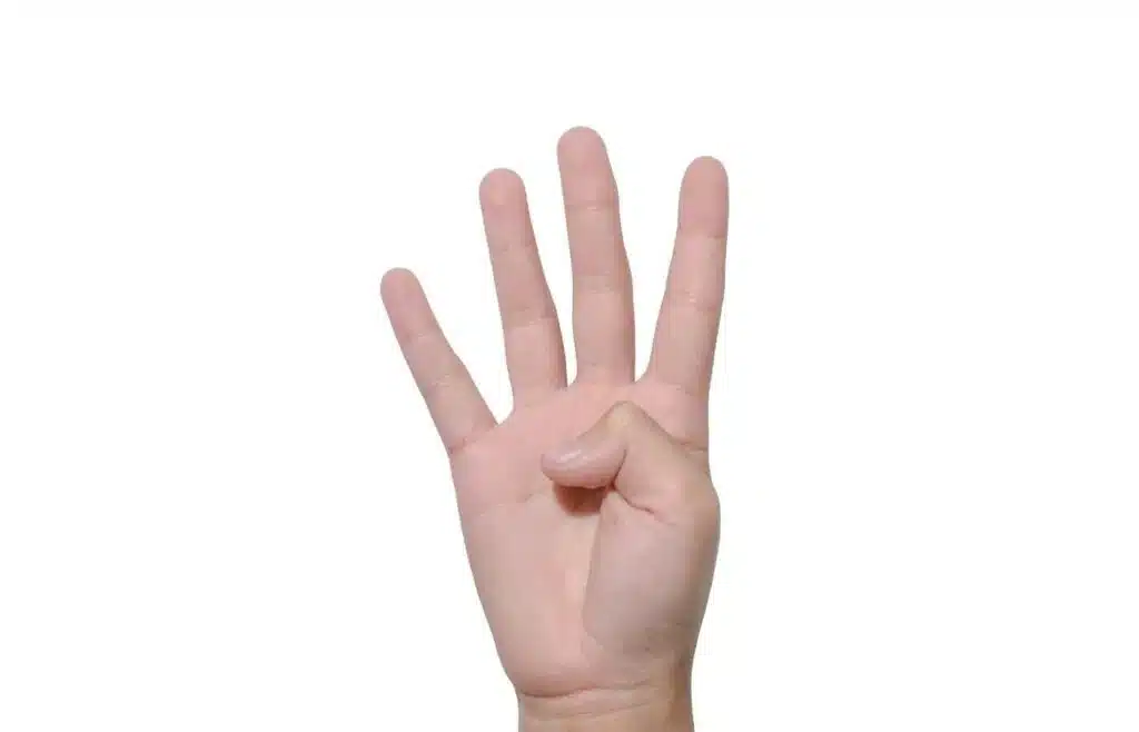 Hand holding up four fingers during Never Have I Ever