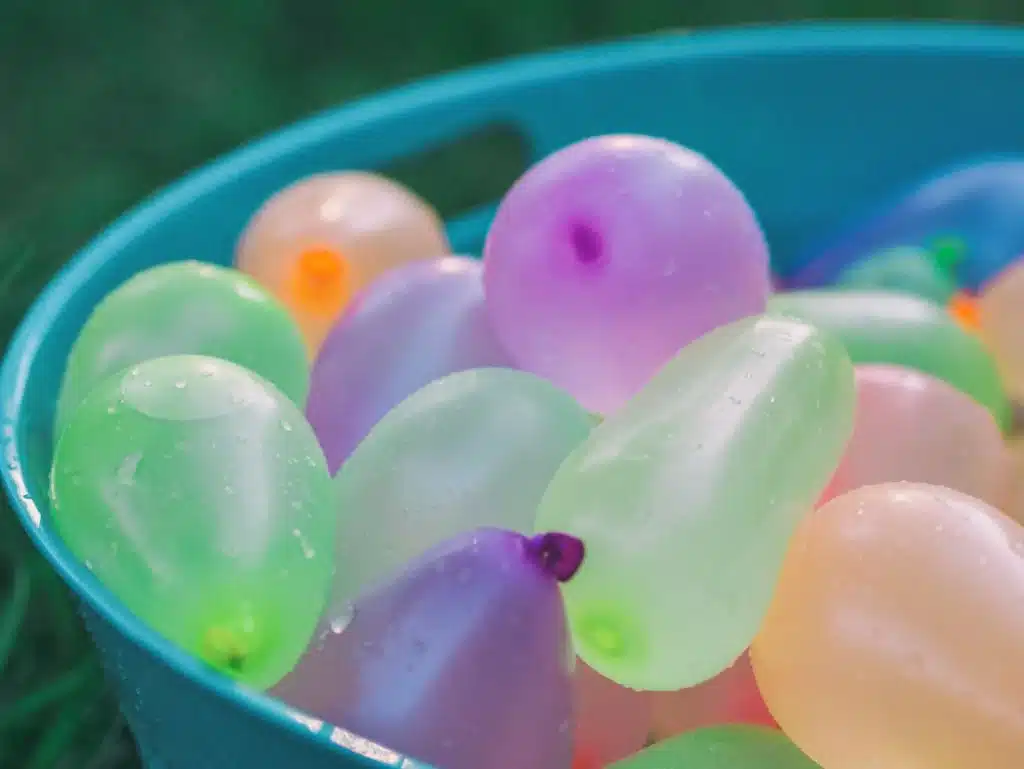 Pastel water balloons in a bucket ready for backyard water balloon games