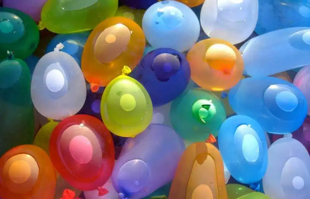 Close-up of colorful water balloons ready for a fun water balloon dodge ball game at a summer party